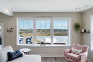 a living room filled with furniture and a large window