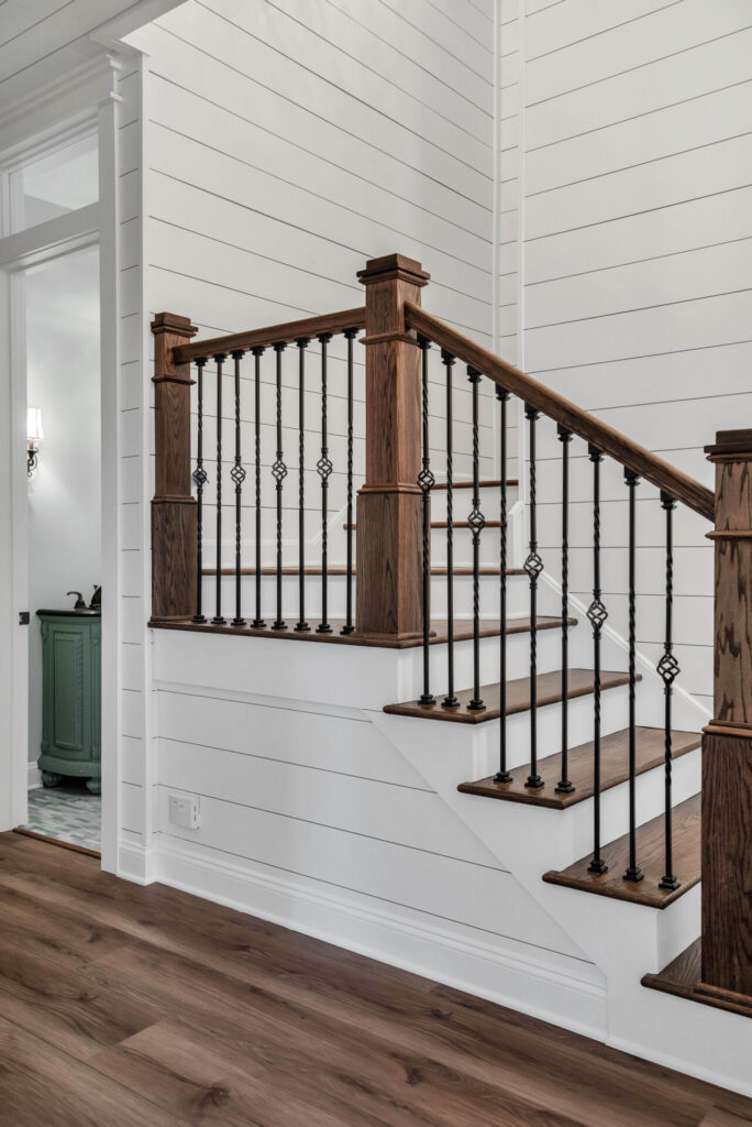 a white house with wood floors and stairs