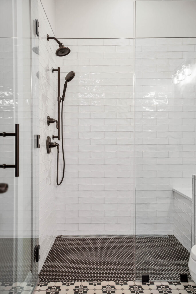 a bathroom with a walk in shower next to a toilet