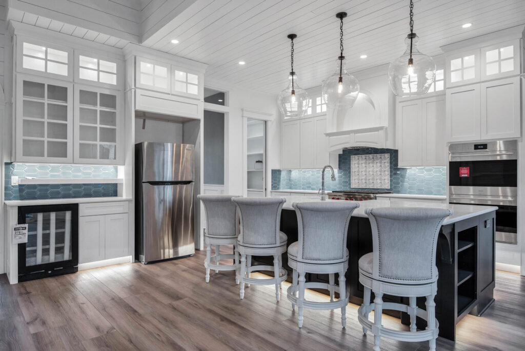 a large kitchen with a center island and bar stools