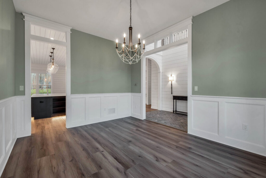 an empty room with a chandelier hanging from the ceiling