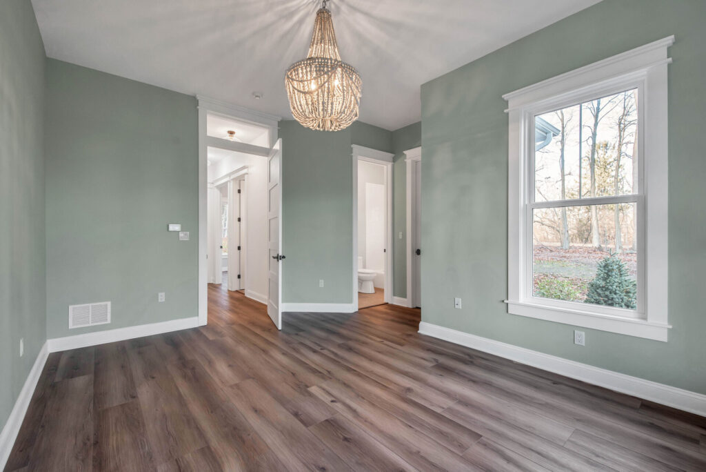 a large empty room with a chandelier hanging from the ceiling