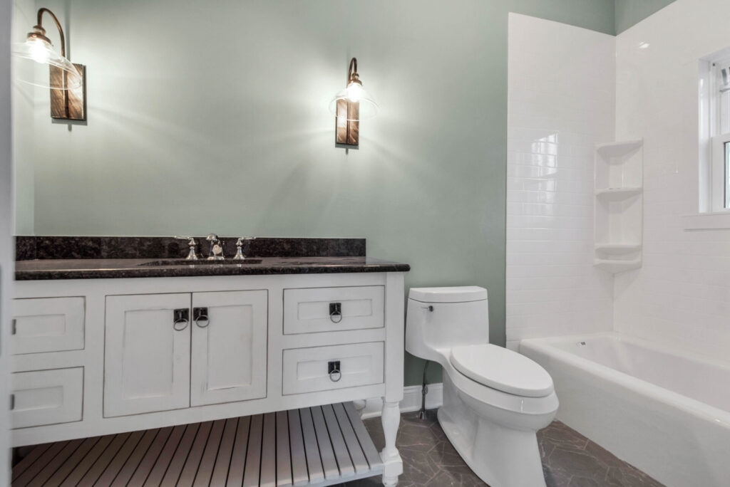 a bathroom with a toilet, sink, and bathtub