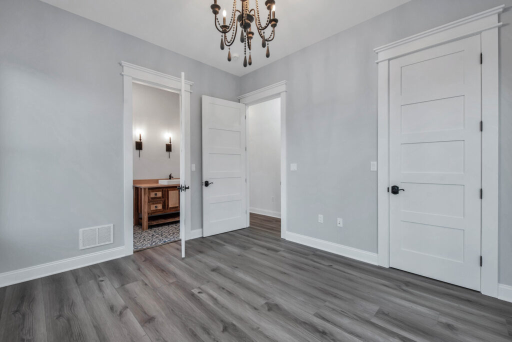 an empty room with a chandelier hanging from the ceiling