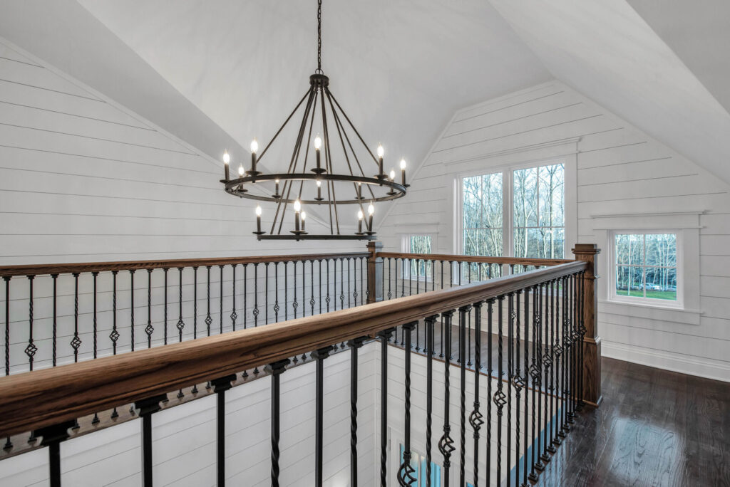 a chandelier hangs from the ceiling of a white room