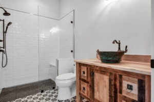 a bathroom with a sink, toilet, and shower