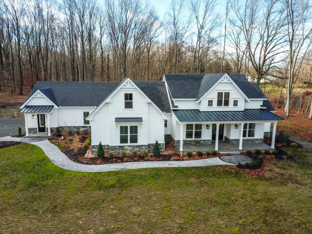 a white house in the middle of a wooded area